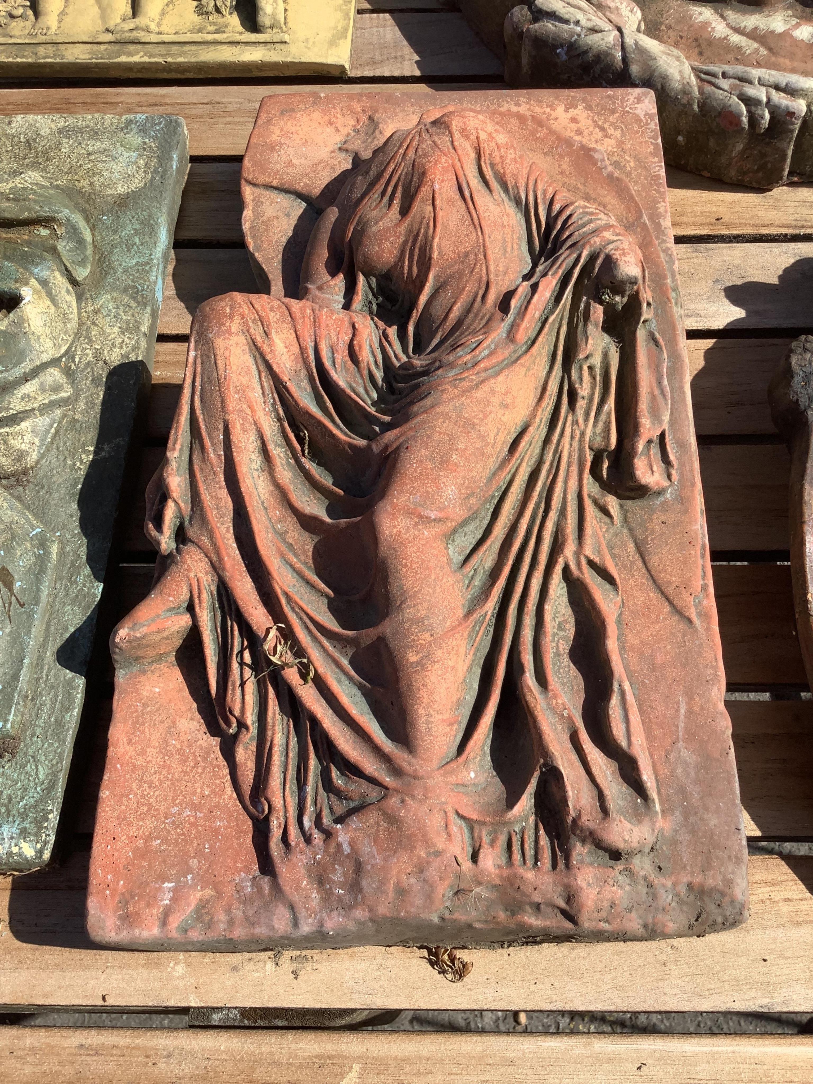 Five cast stone and terracotta garden wall plaques, largest diameter 41cm